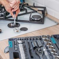 wp:2402 man-s-hand-repairs-hotplate-of-gas-panel-with-screwdriver1-scaled-1.jpeg