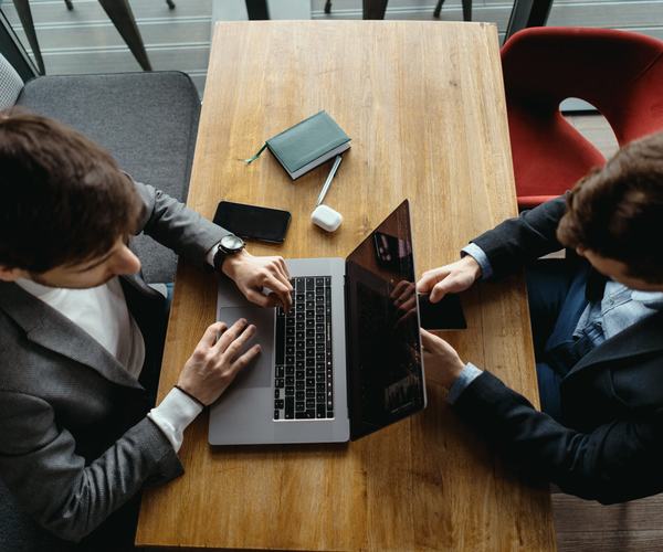wp:7223 two-men-working-laptop-meeting-cafe-scaled.jpg