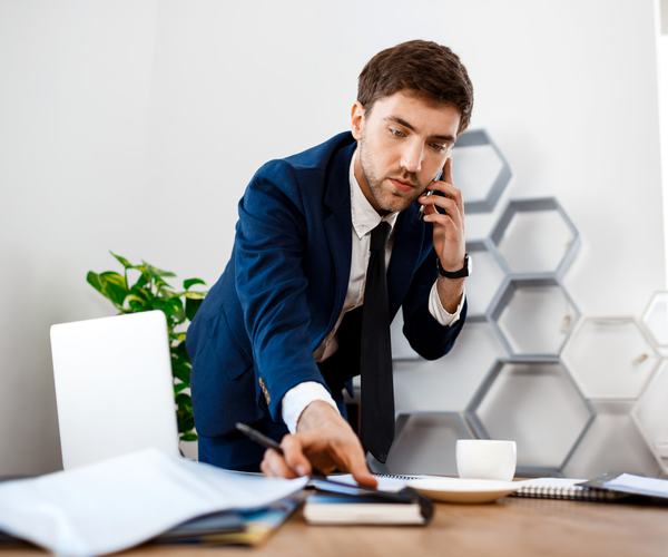 wp:7333 young-successful-businessman-speaking-phone-office-background-2-scaled.jpg